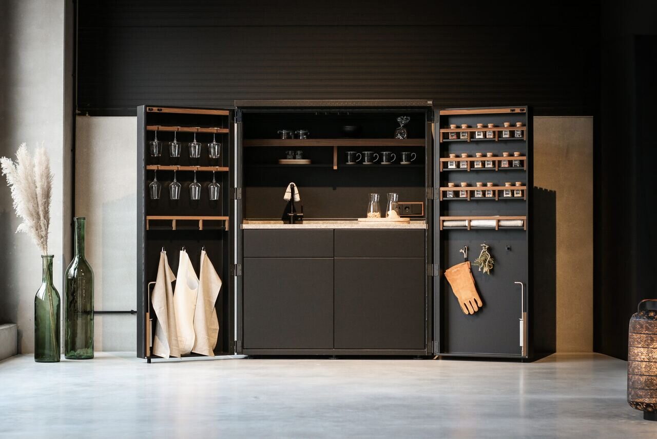 Cubic Kitchen in a Cupboard, open and styled in a dark studio